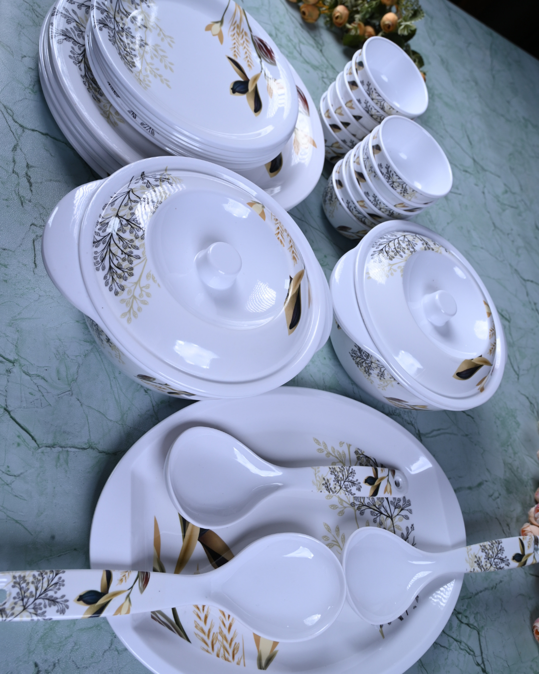 Stacked floral plates and bowls on dark surface