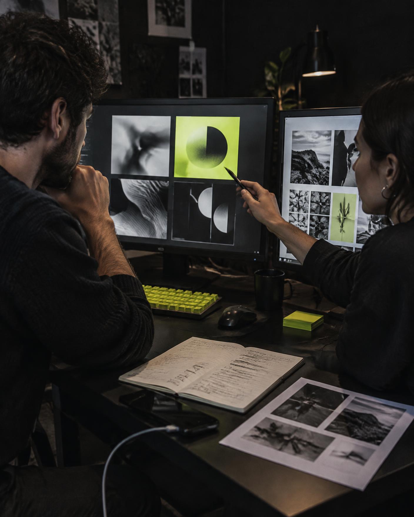 Two agency team members reviewing AI-assisted creative drafts